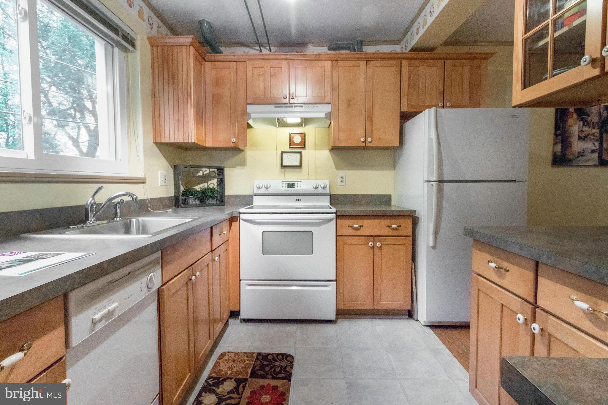 3 Crescent Road, Unit B Greenbelt, MD 20770 - Photo 8 of 22 a kitchen with a white cabinets and white appliances