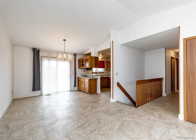 a view of kitchen with refrigerator and window