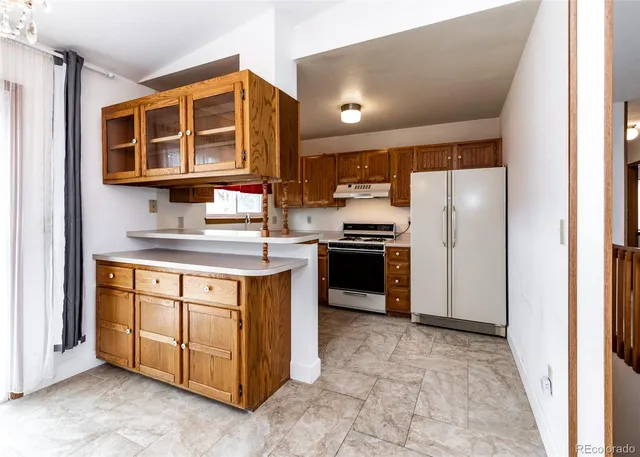 a kitchen with stainless steel appliances granite countertop a stove and a refrigerator