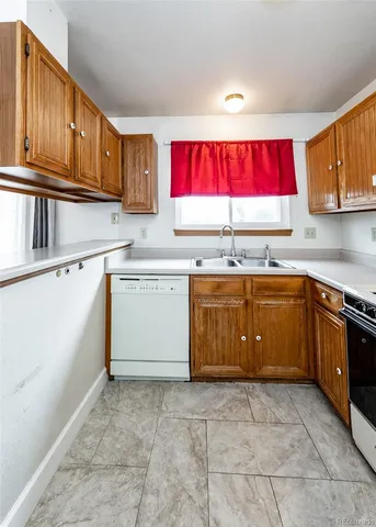 a kitchen with a stove a sink a microwave and cabinets