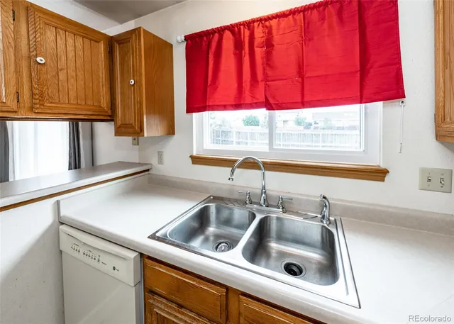 a kitchen with a sink cabinets and a window