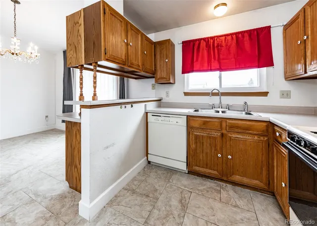 a kitchen with a sink window and cabinets