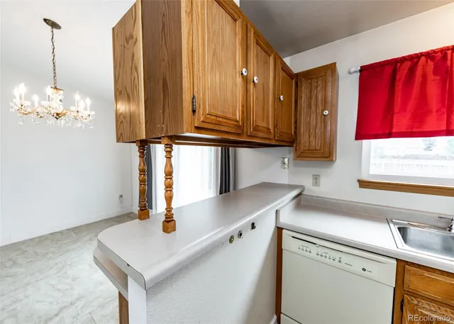 a kitchen with stainless steel appliances cabinets a sink and a window