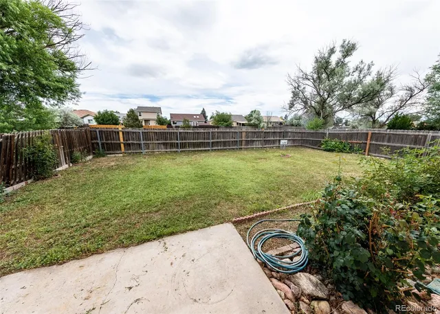 a view of a backyard with swimming pool