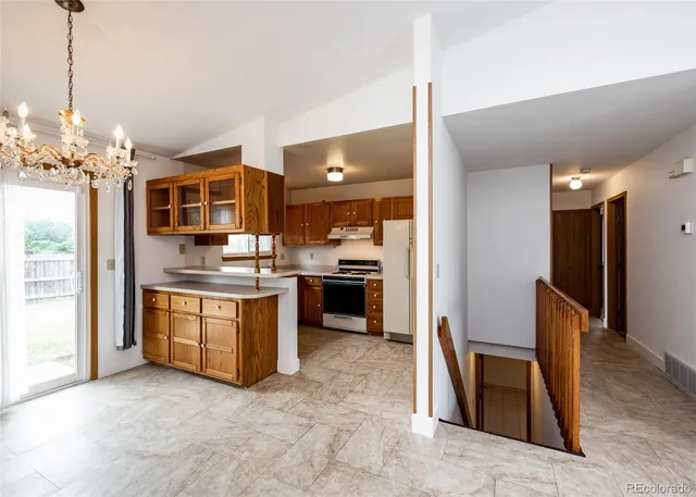 a kitchen with refrigerator and cabinets