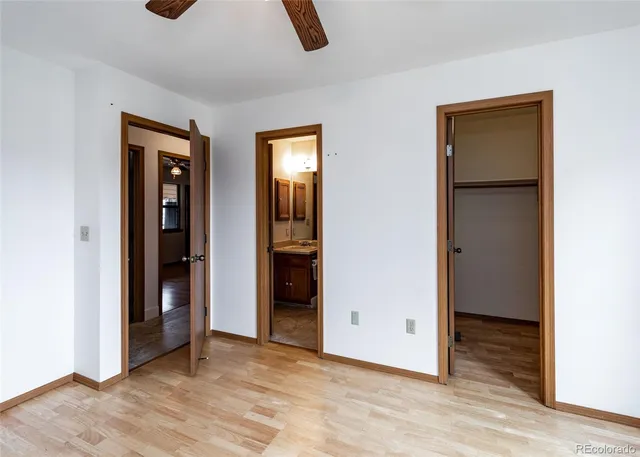 an empty room with closet and windows