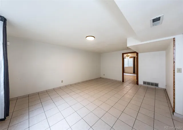 a view of an empty room with closet