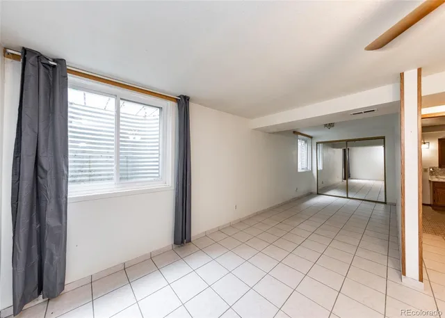 a spacious bathroom with a double vanity sink a mirror and a shower