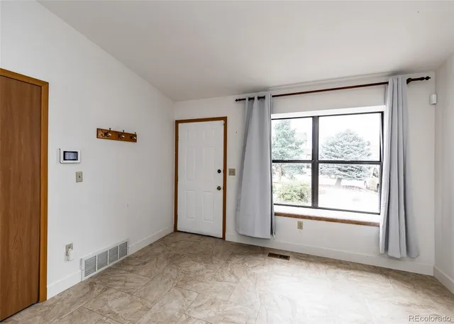 a view of an empty room with a window