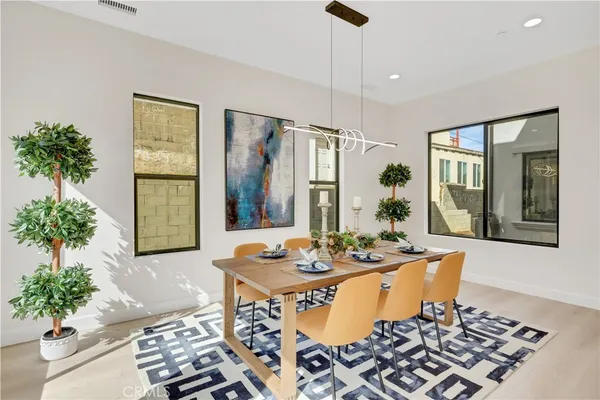 a dining room with furniture window and wooden floor