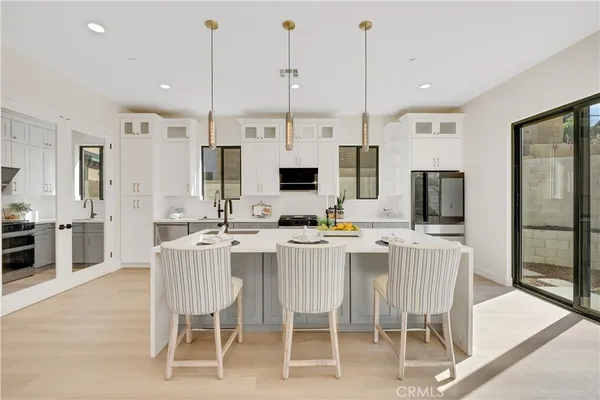 a large kitchen with a table and chairs