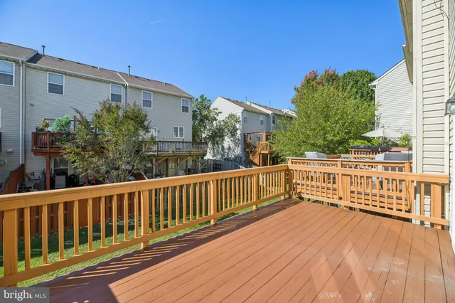 a view of balcony with wooden floor and fence