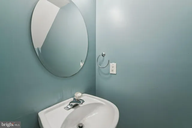 a bathroom with a sink and mirror