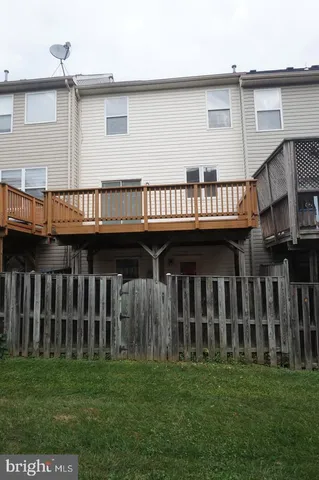 a view of a house with a garden and deck