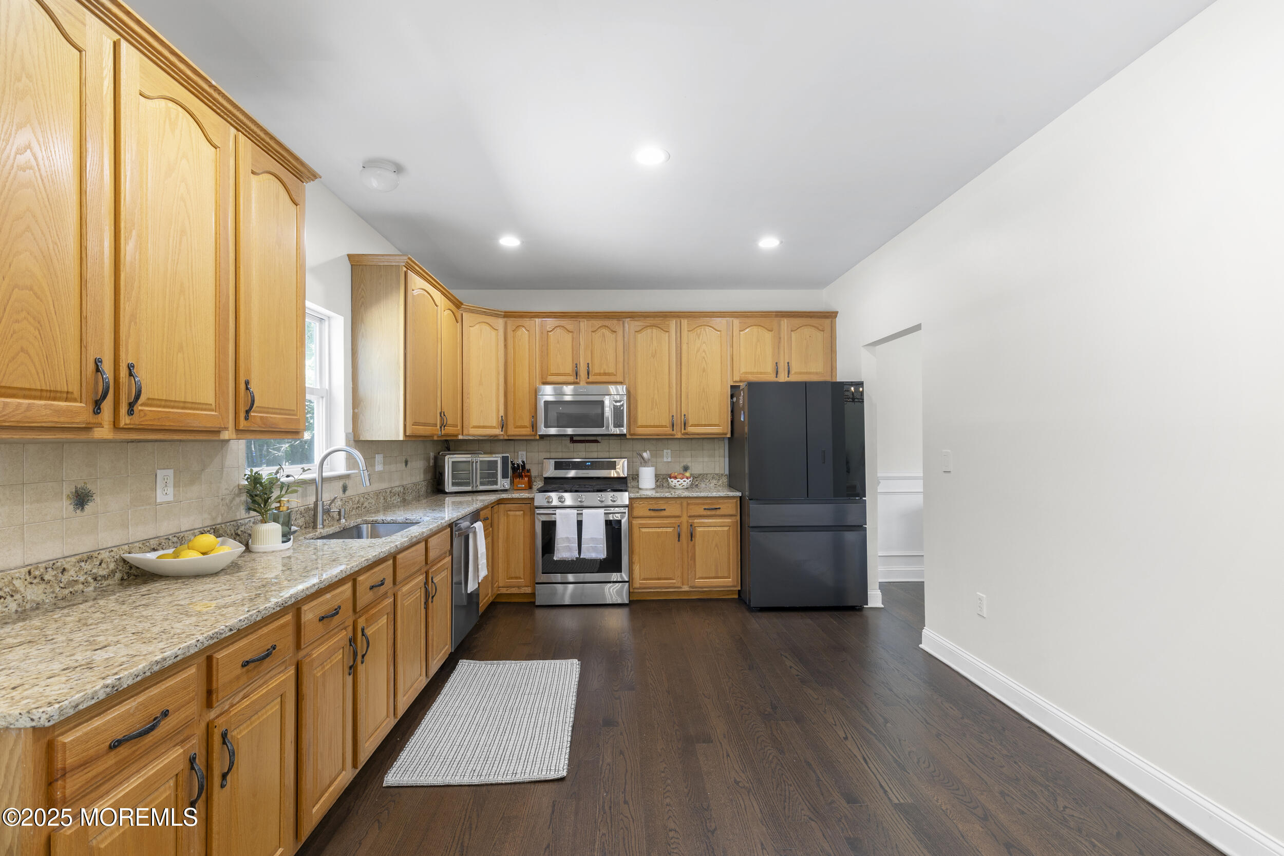 6 Kindling Way Jackson, NJ 08527 - Photo 16 of 54 a kitchen with stainless steel appliances granite countertop a refrigerator a sink dishwasher a stove with wooden cabinets and wooden floor