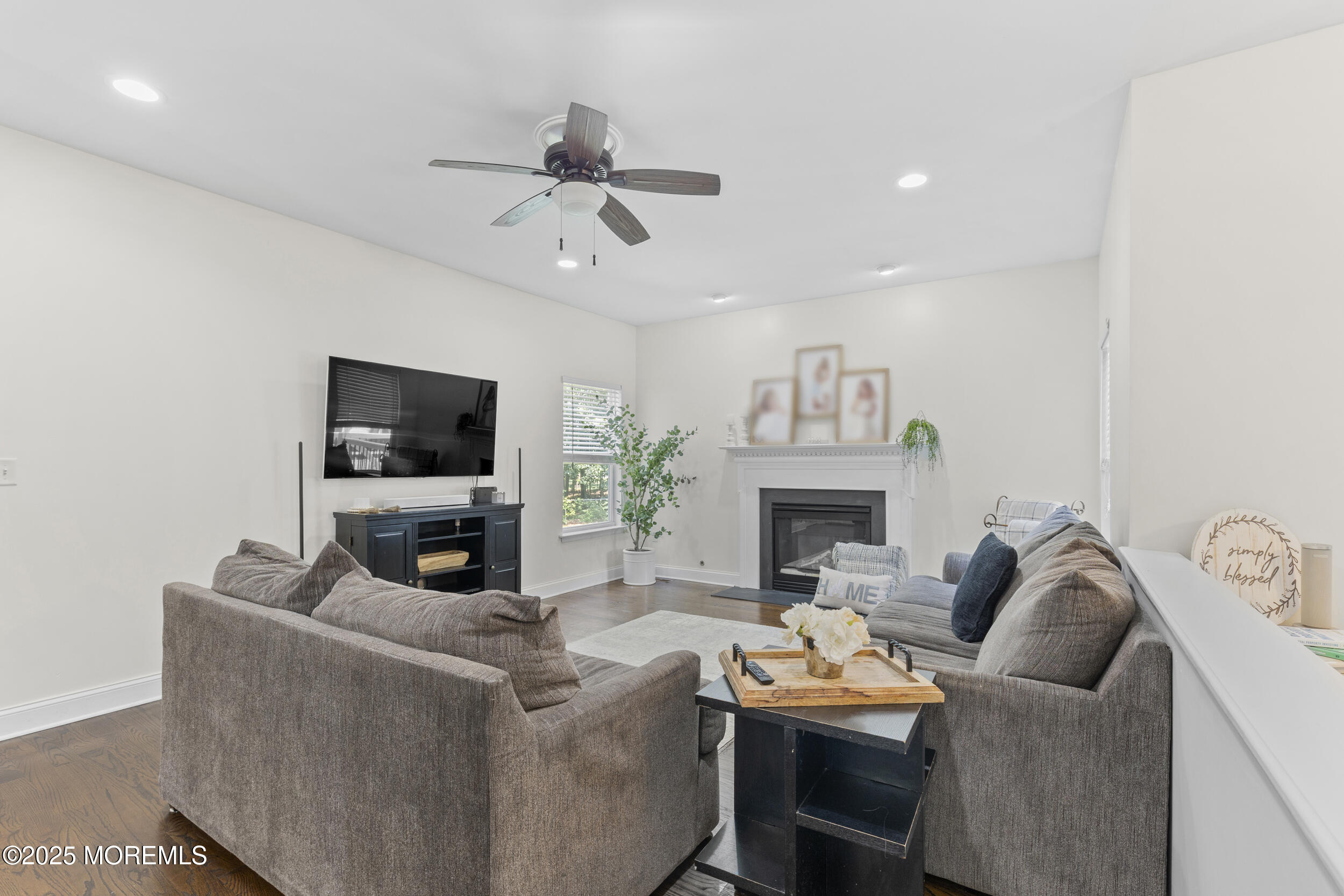 6 Kindling Way Jackson, NJ 08527 - Photo 21 of 54 a living room with furniture a fireplace and a flat screen tv