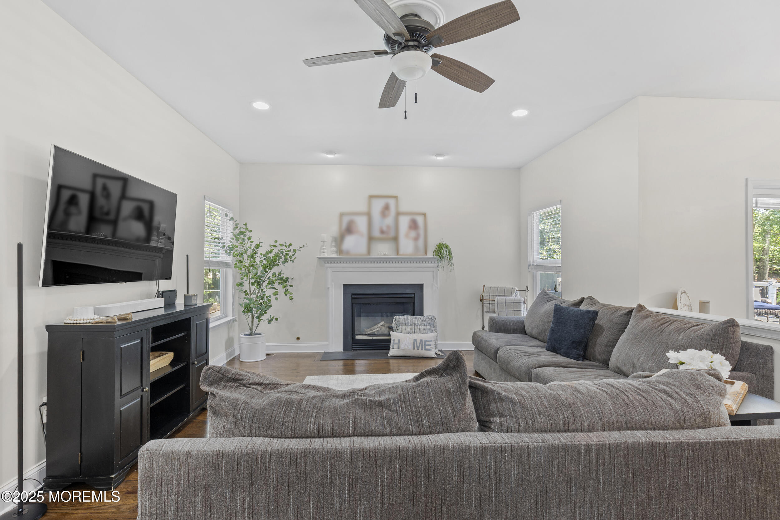6 Kindling Way Jackson, NJ 08527 - Photo 23 of 54 a living room with furniture a fireplace and a flat screen tv