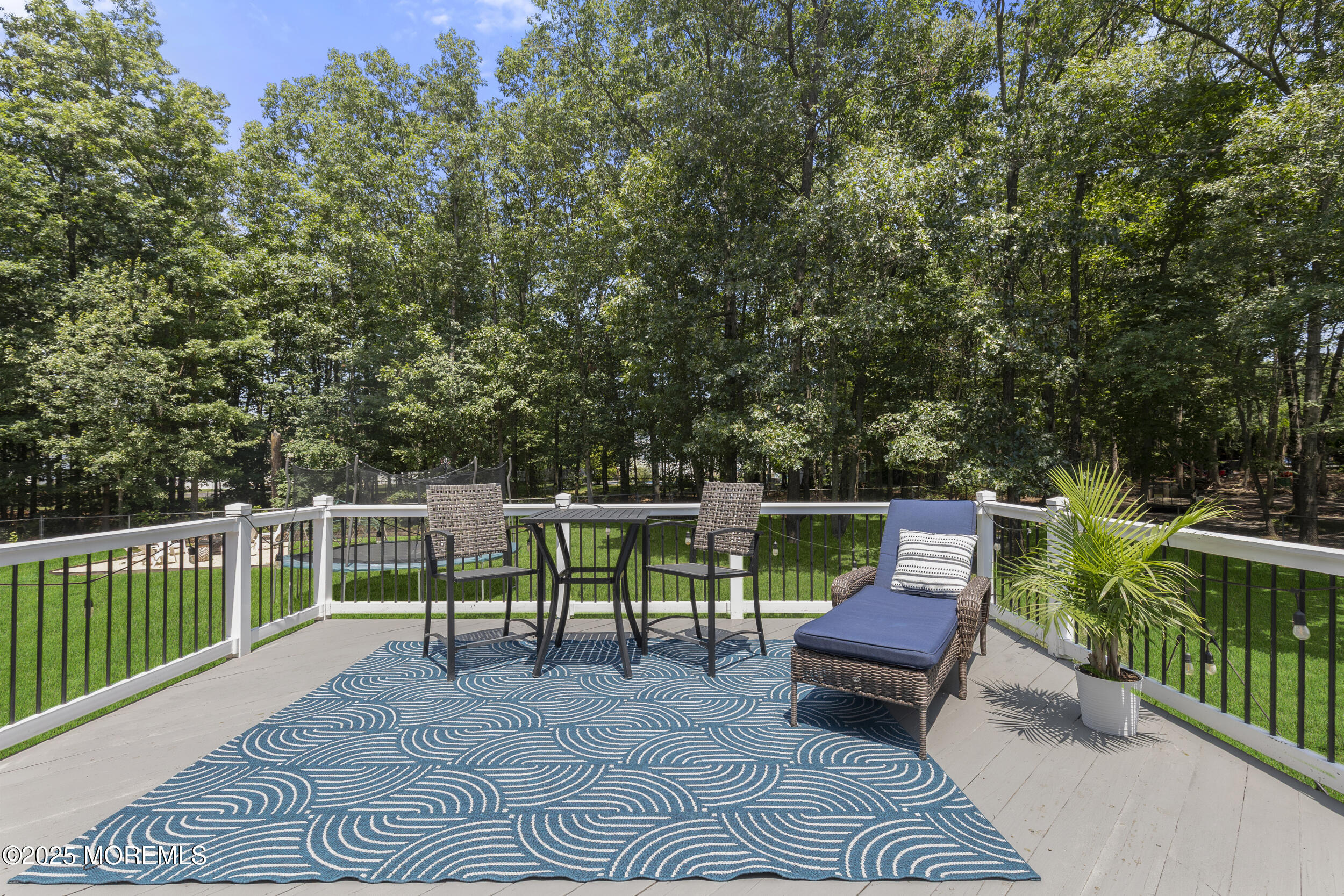 6 Kindling Way Jackson, NJ 08527 - Photo 40 of 54 a view of a chairs and table in the back yard of a house