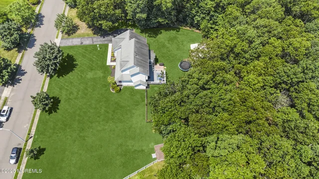 an aerial view of a house with a yard