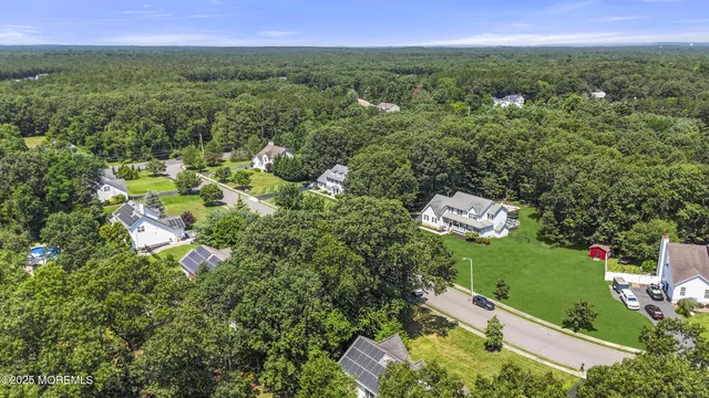 an aerial view of a house with a yard