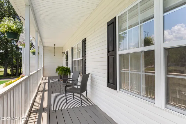 a view of a hallway with wooden floor and stairs