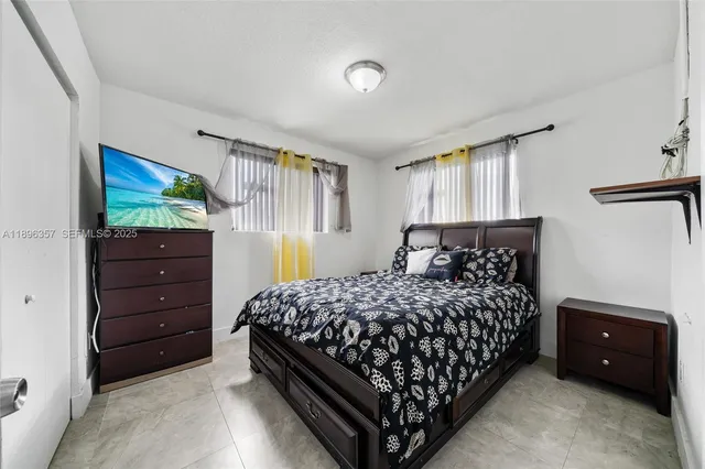 a bedroom with a bed and a dresser