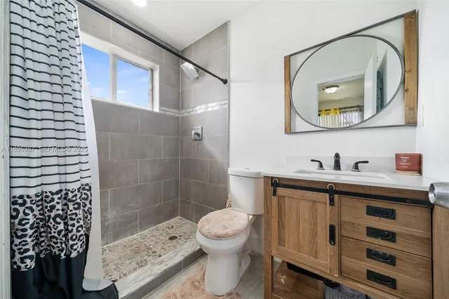 a bathroom with a sink a toilet and a mirror