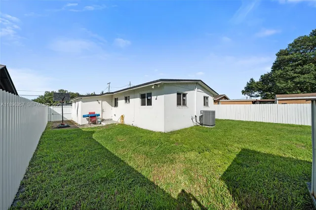 a view of a backyard with plants and a garden
