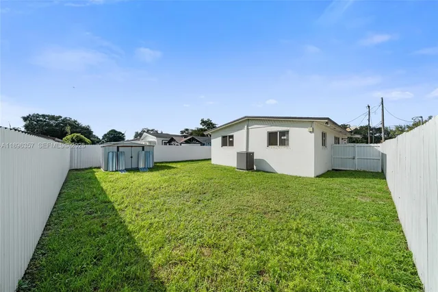 a view of a backyard with plants and a garden