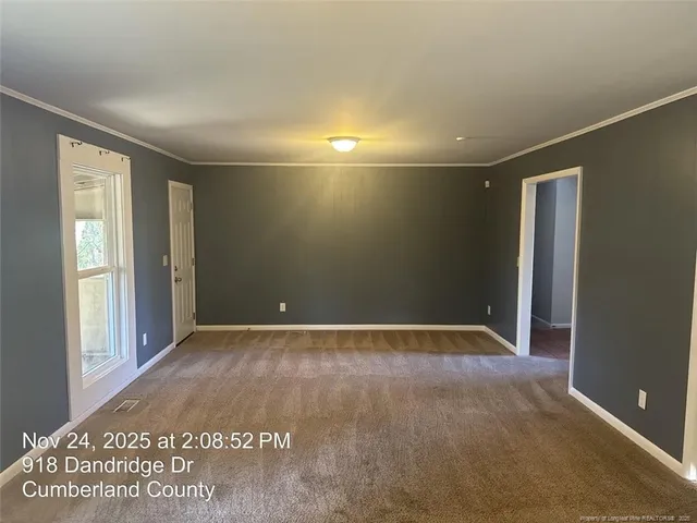 a view of an empty room with a window