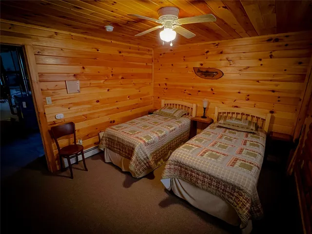 a bedroom with two bunk beds and a chair