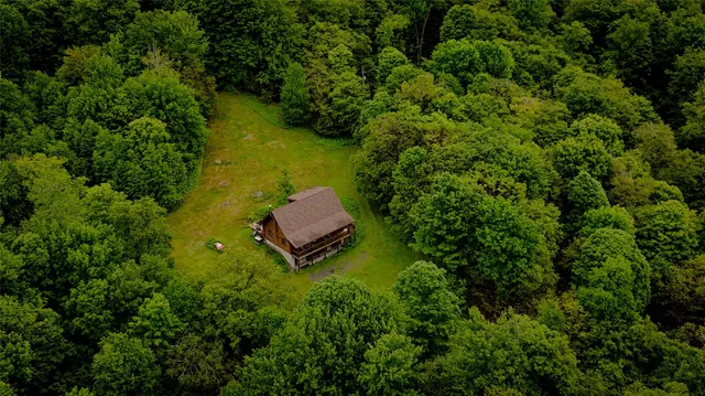 an aerial view of a house with a yard
