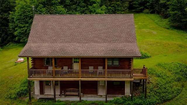 an aerial view of a house with swimming pool and garden