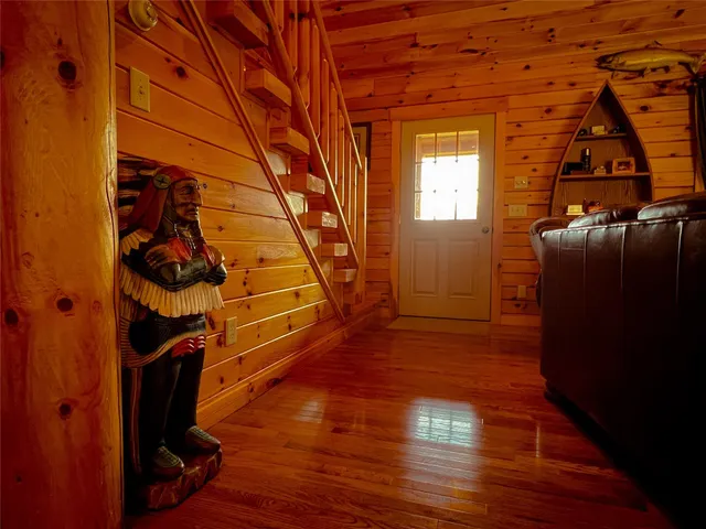 a view of a livingroom with wooden floor and a window