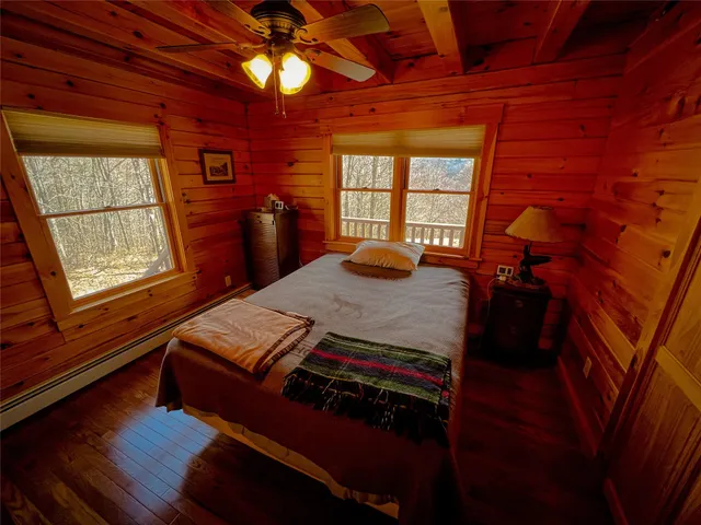 a bed sitting in a bedroom next to a window