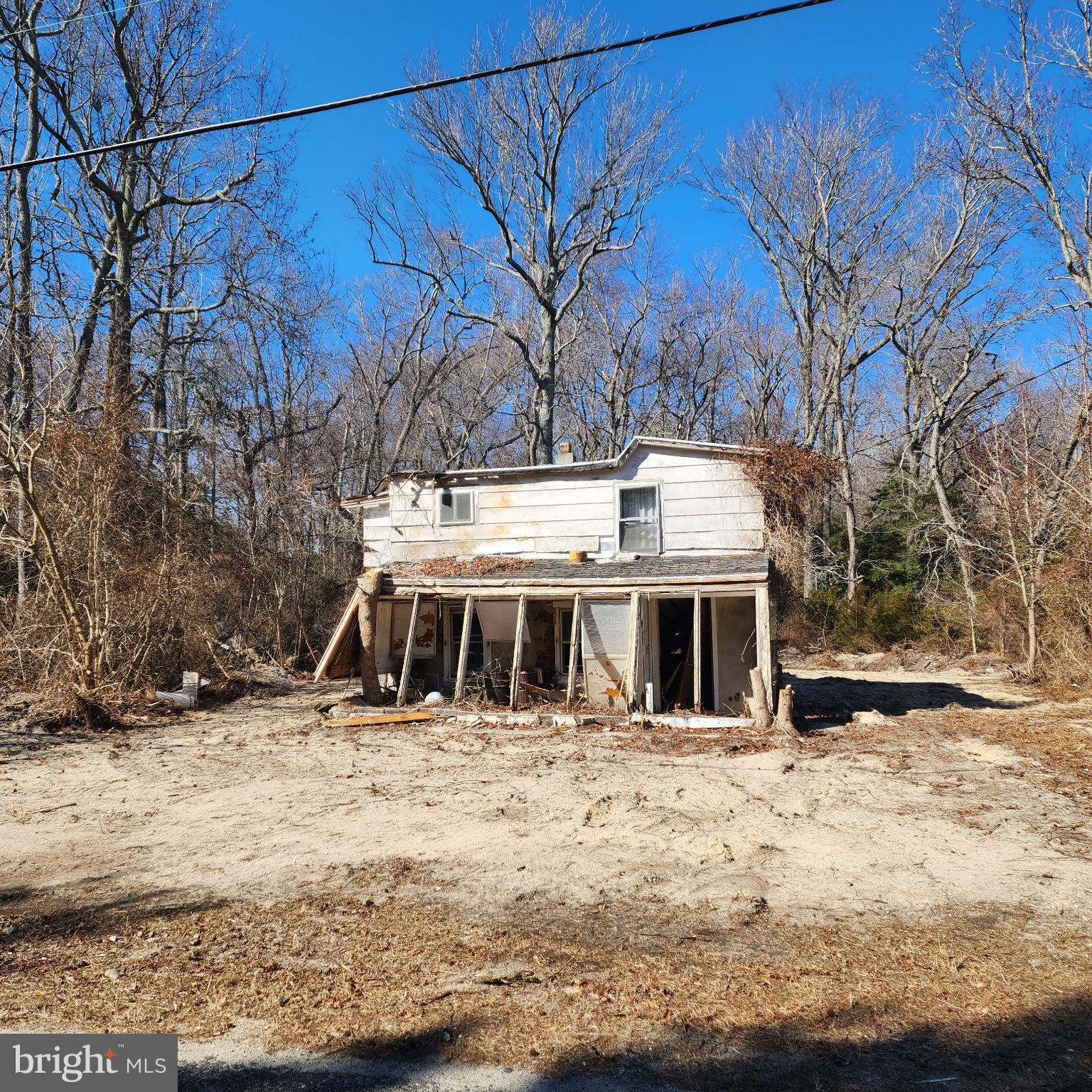 112 Sheppard Davis Road Cedarville, NJ 08311 - Photo 2 of 5 Abandoned charm amidst nature's embrace.