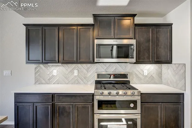 a kitchen with a stove and a microwave
