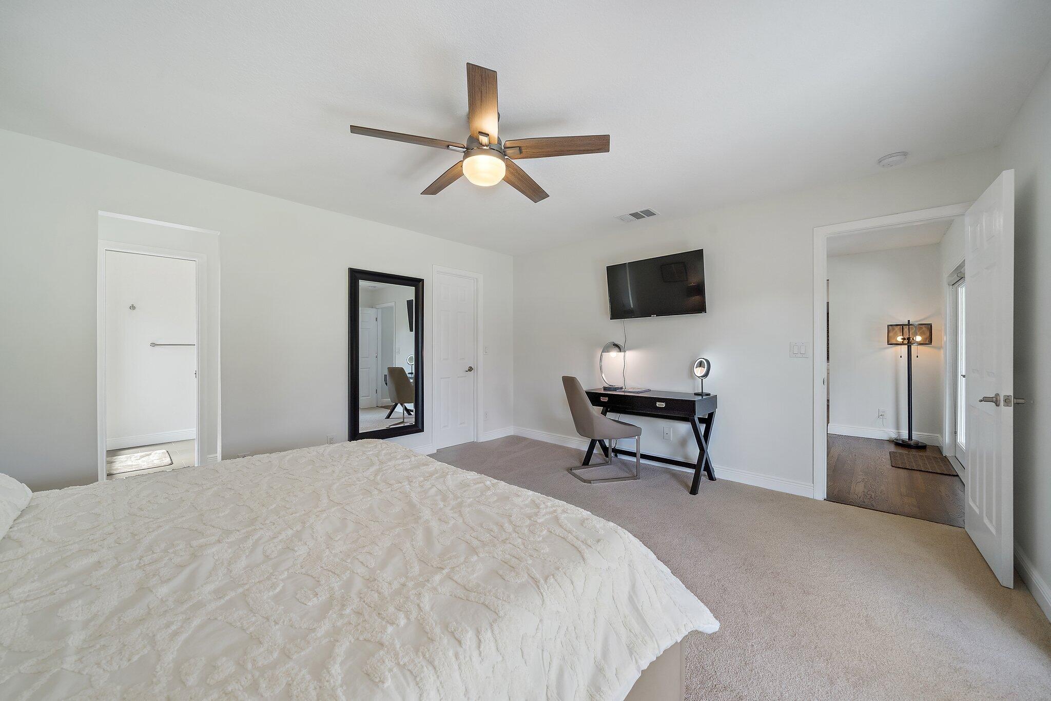 1342 Essex Drive Wellington, FL 33414 - Photo 12 of 58 a bedroom with a bed and a chandelier