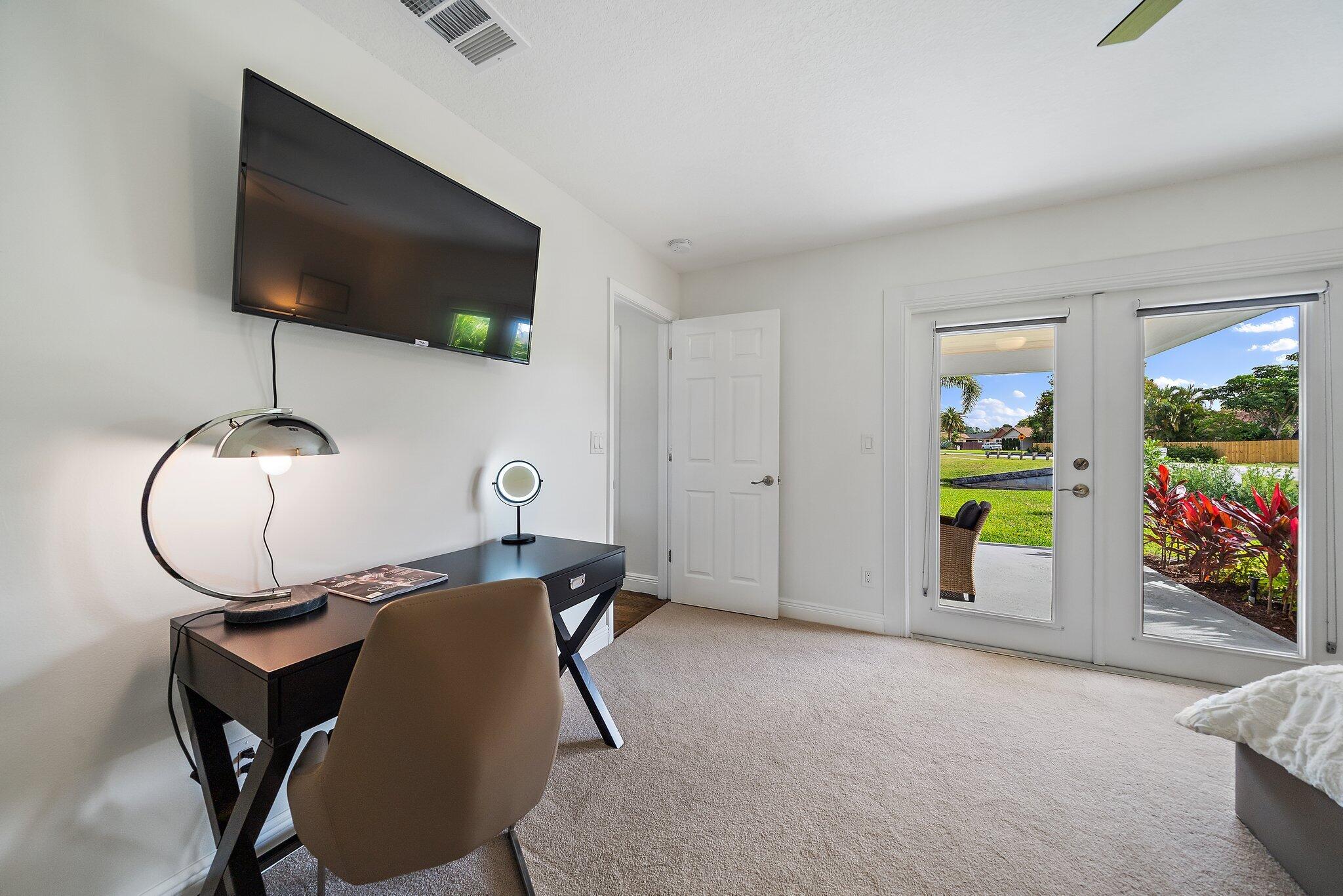 1342 Essex Drive Wellington, FL 33414 - Photo 13 of 58 a view of a livingroom with furniture and a flat screen tv