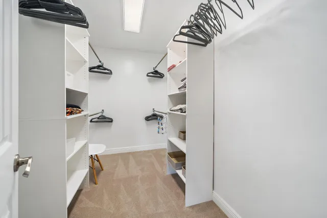 a bedroom with a bed a window and a flat screen tv