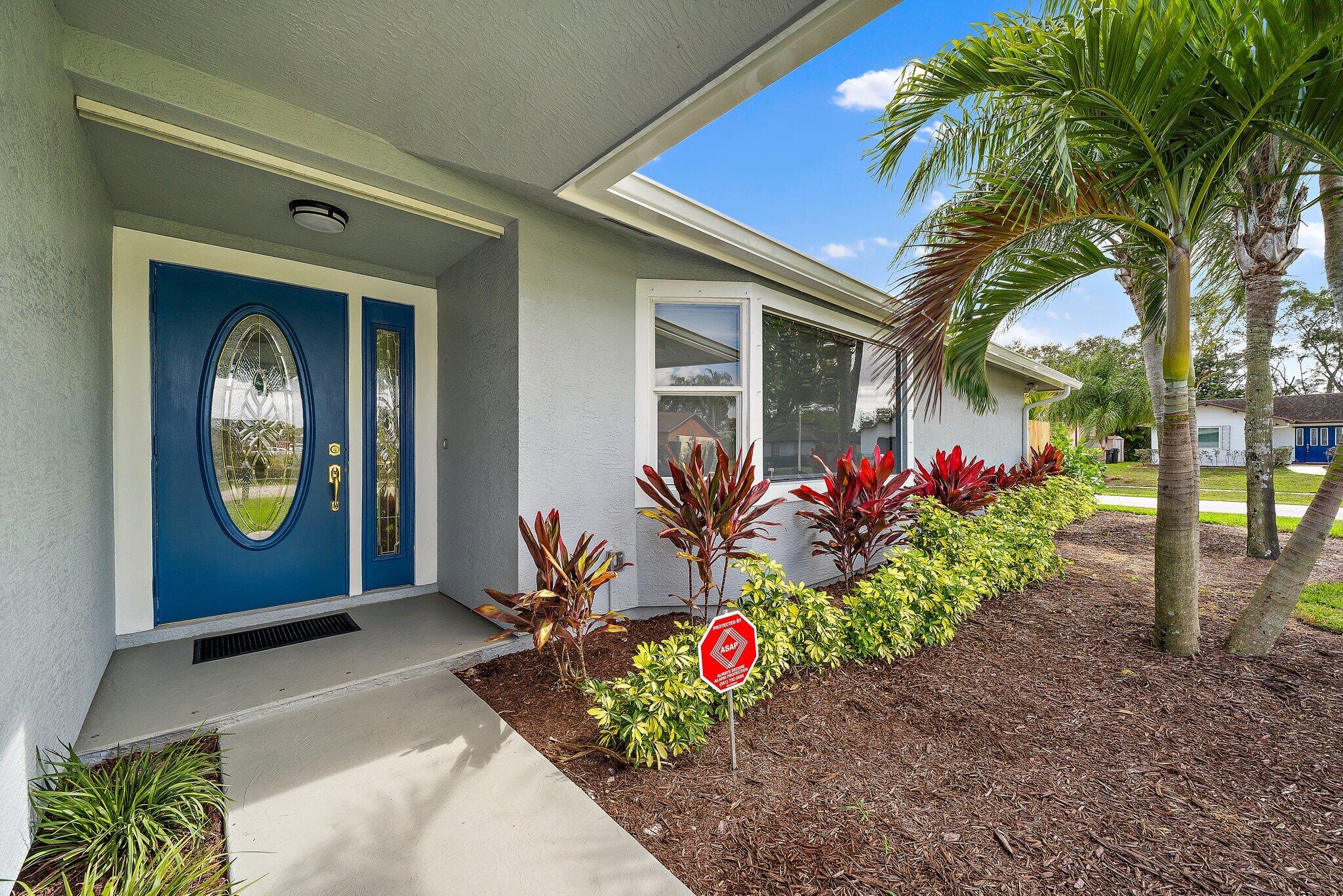 1342 Essex Drive Wellington, FL 33414 - Photo 2 of 58 a front view of a house with a porch