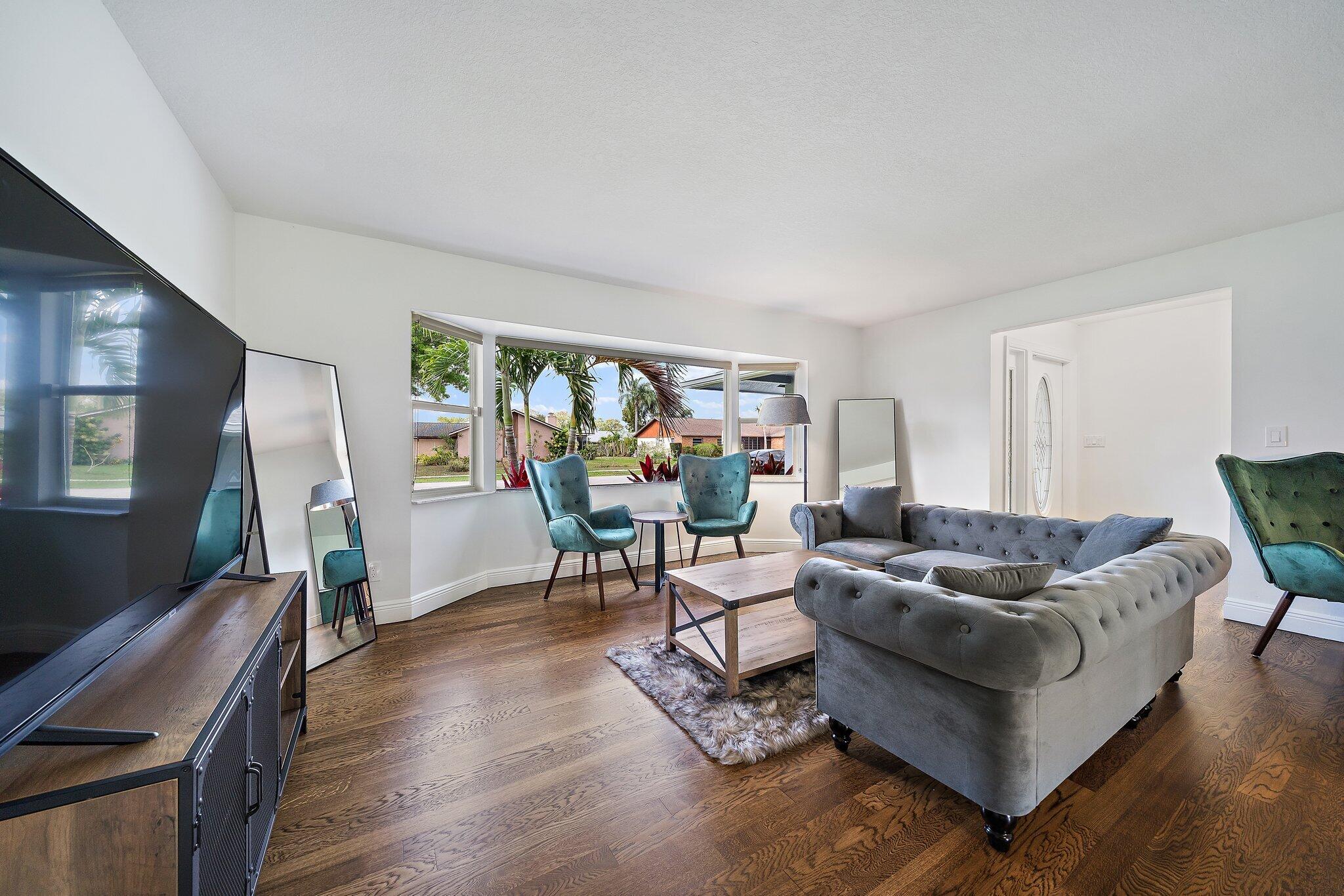1342 Essex Drive Wellington, FL 33414 - Photo 21 of 58 a living room with furniture and wooden floor