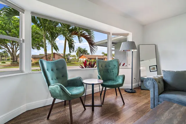 a kitchen with stainless steel appliances granite countertop a refrigerator a sink a stove and white cabinets