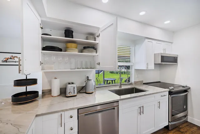 a living room with furniture windows and a fireplace