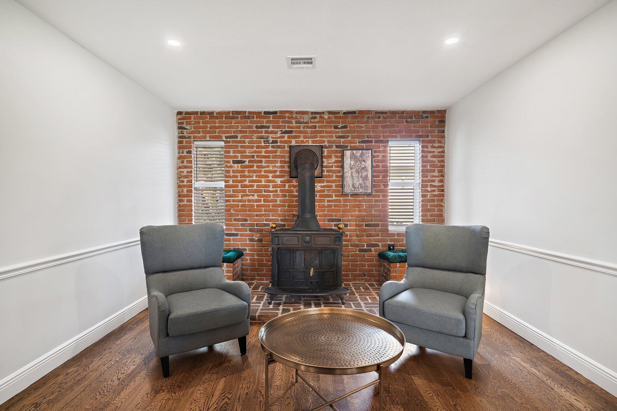1342 Essex Drive Wellington, FL 33414 - Photo 31 of 58 a living room with furniture windows and a fireplace