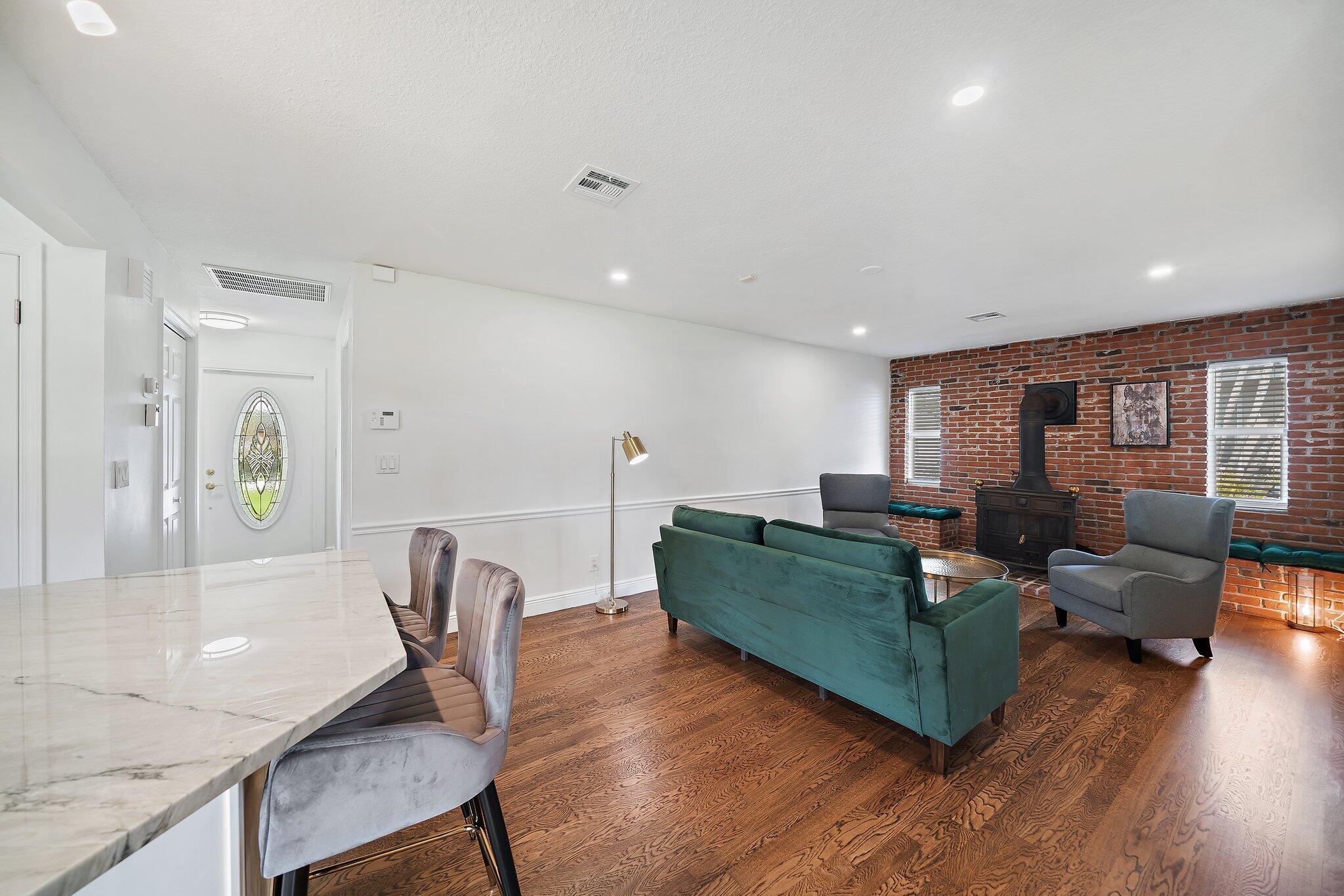 1342 Essex Drive Wellington, FL 33414 - Photo 35 of 58 a living room with furniture and a wooden floor