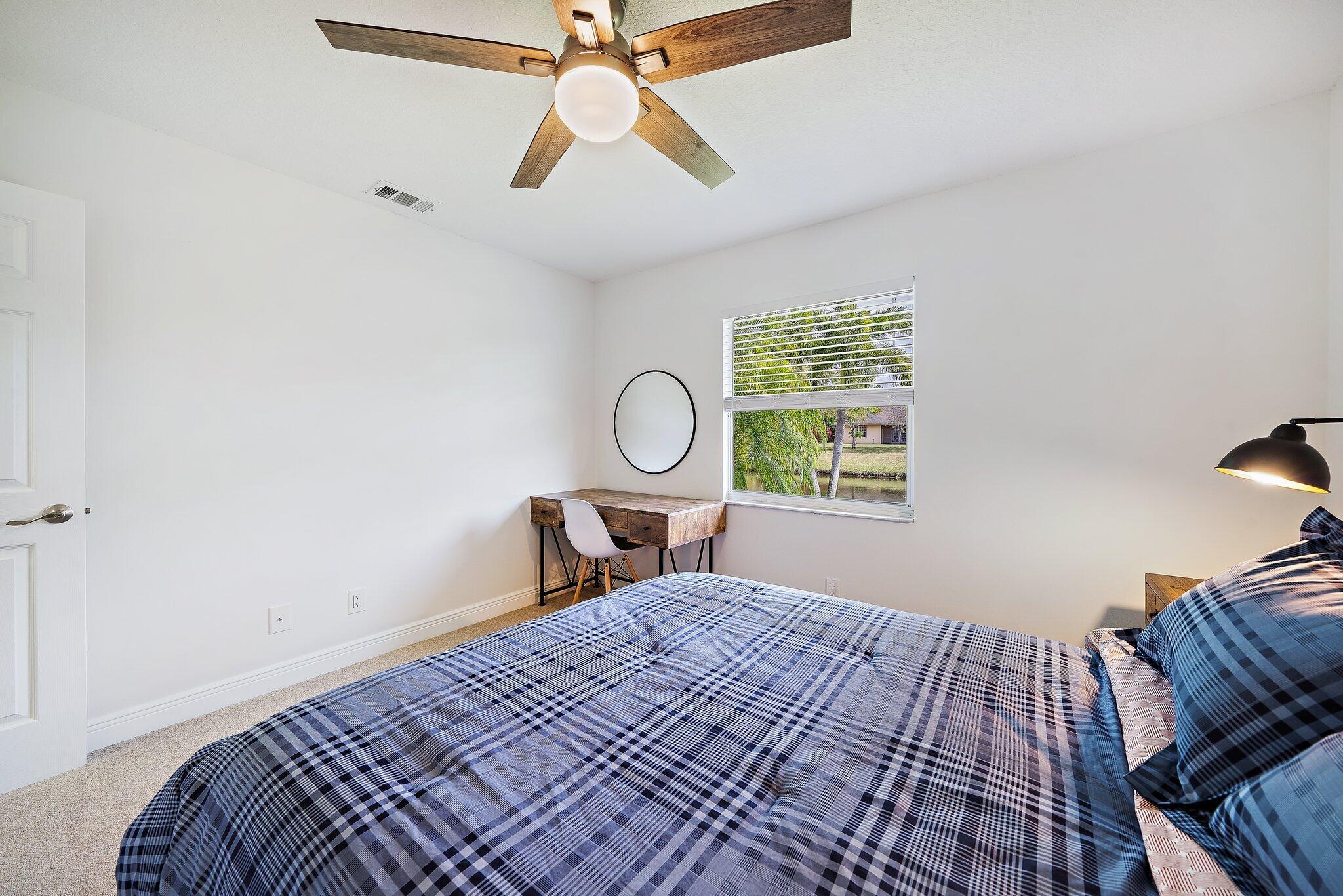 1342 Essex Drive Wellington, FL 33414 - Photo 37 of 58 a bedroom with a bed and a window