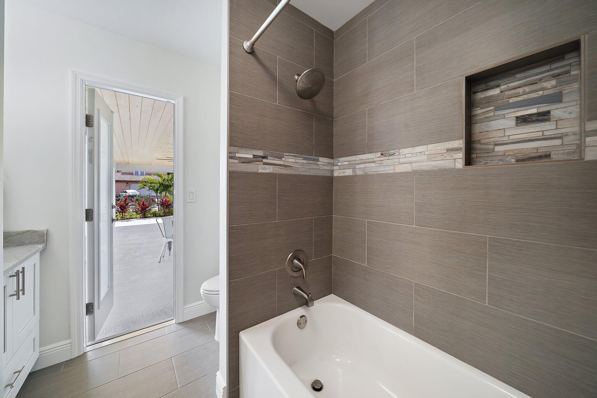 1342 Essex Drive Wellington, FL 33414 - Photo 38 of 58 a bathroom with a white bath tub