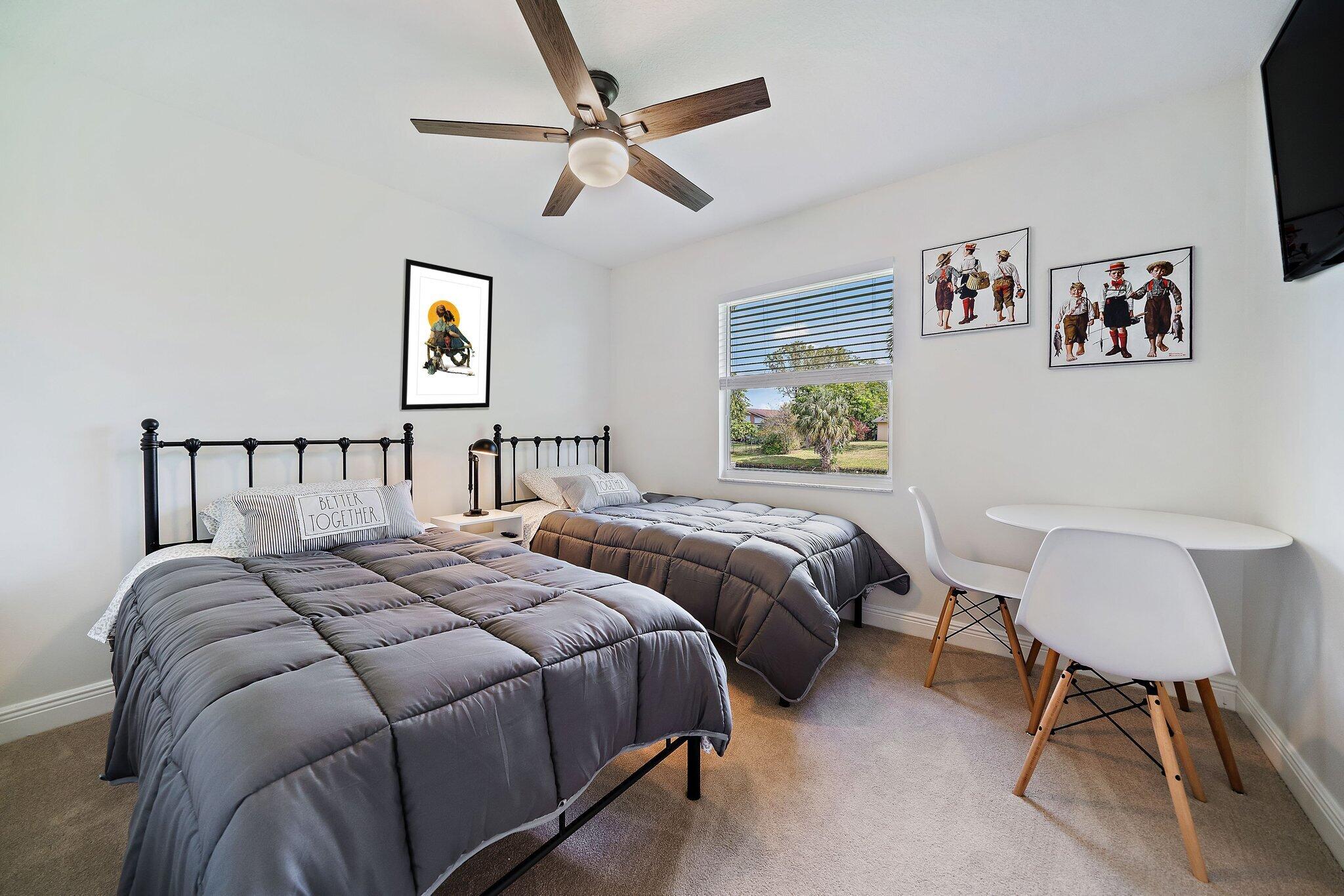 1342 Essex Drive Wellington, FL 33414 - Photo 40 of 58 a bedroom with a bed a chair and a chandelier