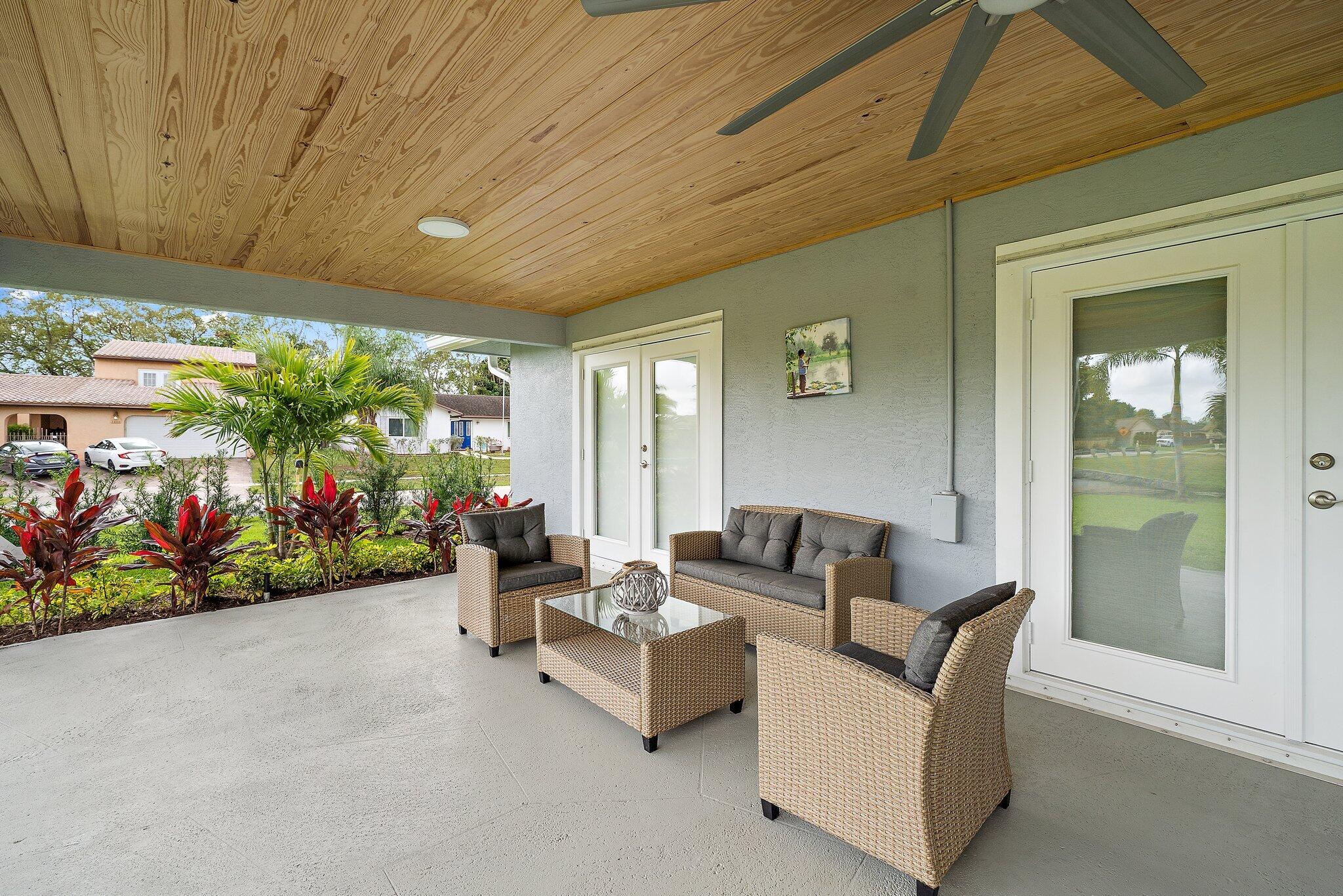 1342 Essex Drive Wellington, FL 33414 - Photo 47 of 58 a building outdoor space with patio furniture and potted plants